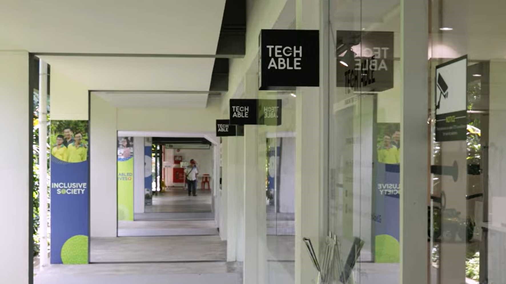 Facade of Tech Able showcase centre with glass doors and along a corridor on the right.